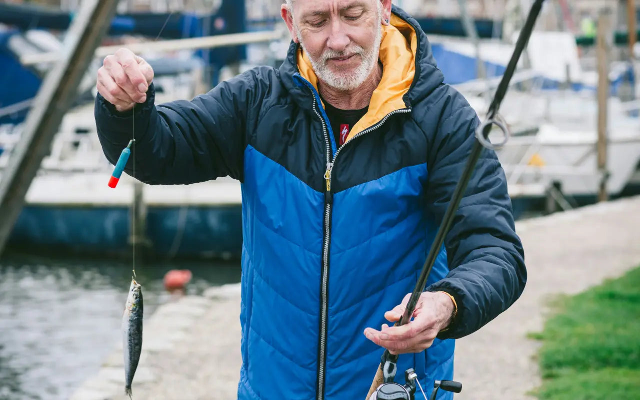 Mann mit Köderfisch an der Angel